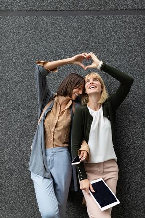 Beautiful happy women friends having fun and good time together outdoorの写真素材