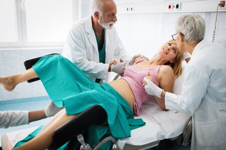 Pregnant woman with doctor in maternity hospital before childbirthの写真素材