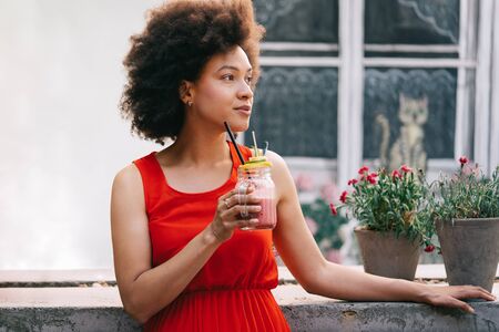 Healthy drinks, diet and people concept. Close up of beautiful afro womanの写真素材