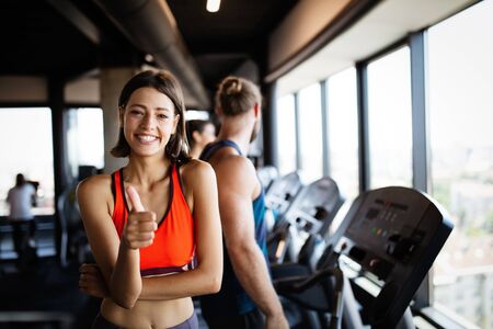 Beautiful fit young woman training in gym