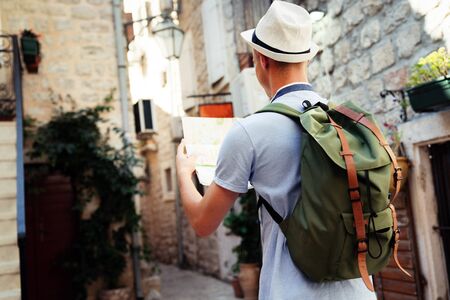 Happy young man smiling and traveling at summer vacationの写真素材