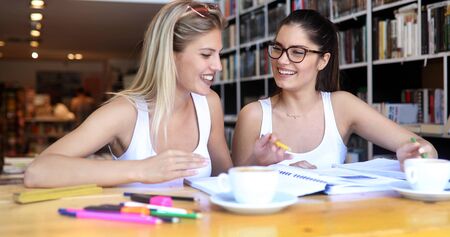 Group of college students studying in the school library