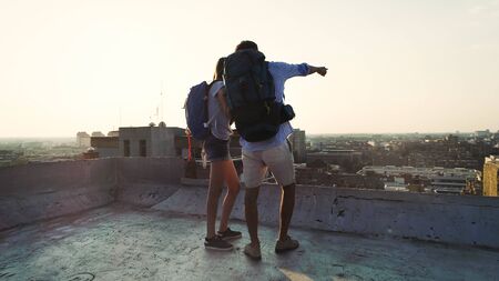 Happy couple on vacation sightseeing city with map