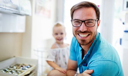 Health care, eyesight and vision concept. Handsome man choosing glasses at optics storeの写真素材