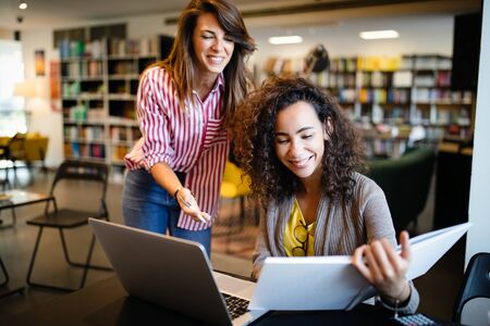 Young university students studying together. Group of multiracial friends in collegeの写真素材