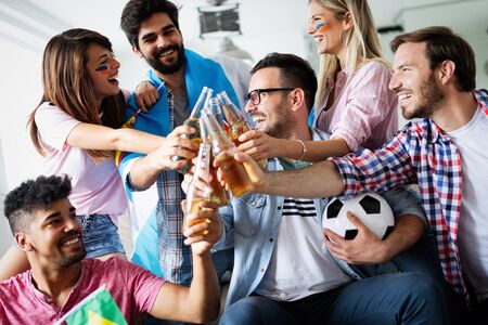 Group of multi-ethnic people celebrating football game
