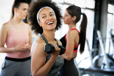 Group of sportive people in a gym. Concepts about lifestyle and sport in a fitness clubの写真素材