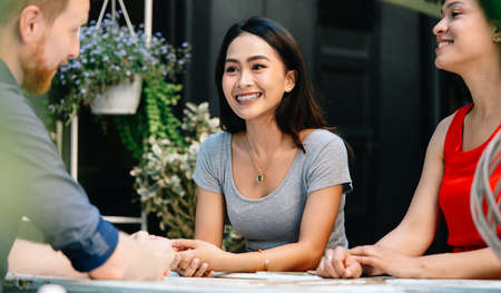 Friends having a great time in cafe, smiling and drinking cocktails enjoying together.の写真素材