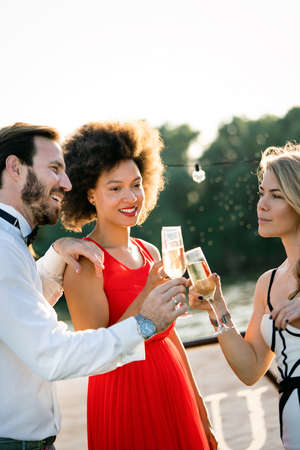 Group of happy friends partying and toasting drinksの写真素材