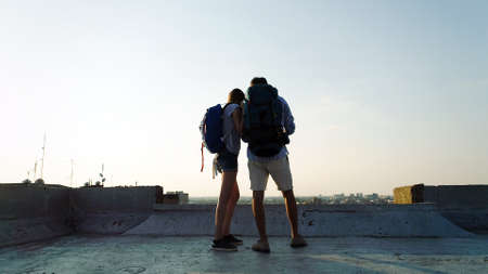 Happy young couple with a city map and a backpack travelling
