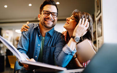 Couple in love spendig fun time together. Reading, work, study, happiness concept