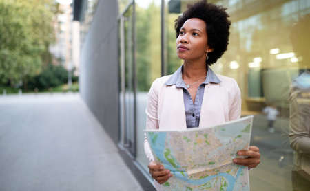 Young beautiful woman traveler lost in the city. Tourism, vacation, people concept