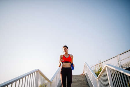 Happy young woman exercising outdoors. Living healthy lifeの写真素材
