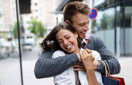 Beautiful young couple enjoying in shopping, having fun together.