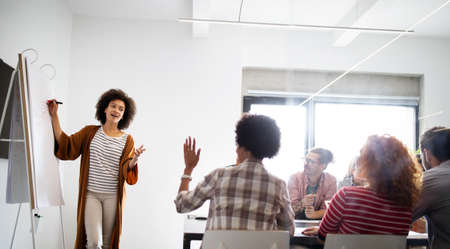 Business partners sharing ideas and planning work at meeting in office