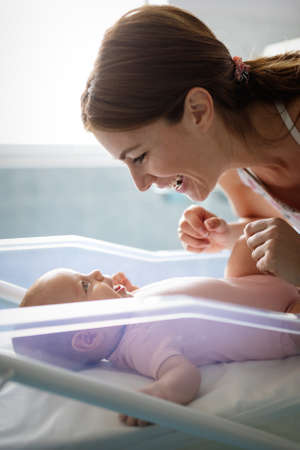 Picture of happy mother playing with sweet baby girlの写真素材