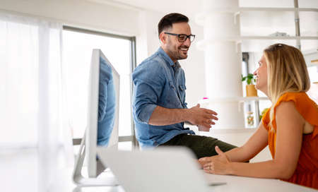 Happy young couple working at home officeの写真素材