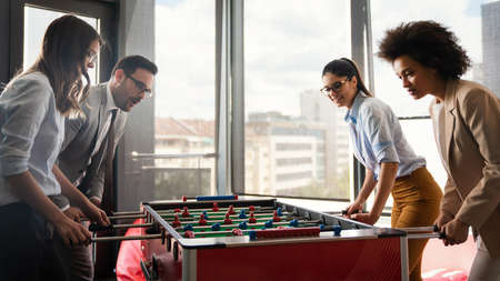 Colleagues playing table football in the break.