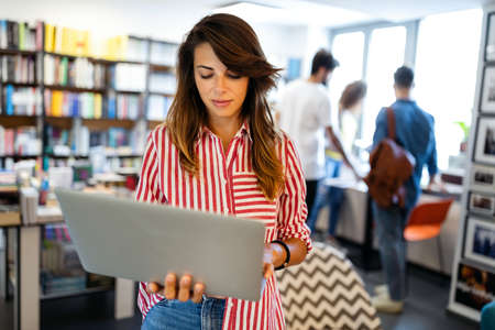 Beautiful young woman working, studying on notebook, computerの写真素材
