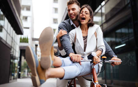 Beautiful happy couple in love on bicycle in the city