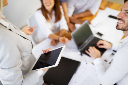 Cheerful coworkers in office during company meeting