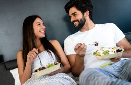 Romantic happy couple having breakfast in bed