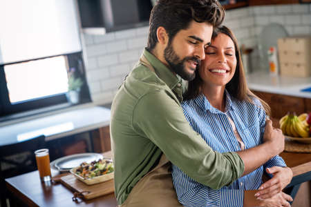 Romantic happy young couple hugging at modern home indoors and have funの写真素材
