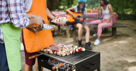 Friends having a barbecue party in nature