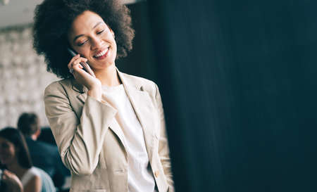 Pretty african american business woman talking on her mobile phoneの写真素材