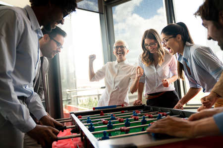 Colleagues playing table football in the break.