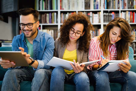 Group of college students studying in the school library.の写真素材