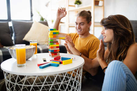 Couple in love enjoying their time together and having fun while playing board game