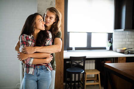 Couple kissing and hugging each other at home. Sexy sensual couple in love.の写真素材