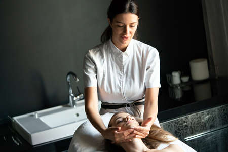Masseur doing massage on woman body in the spa salonの写真素材