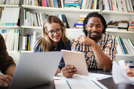 Successful group of designers, business people at work in office