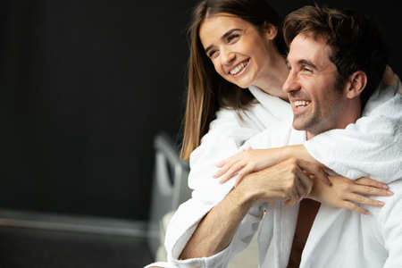 Couple in bathrobes enjoying honeymoon in spa resort