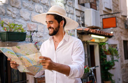 Happy young tourist man having fun and travelling on summer vacationの写真素材