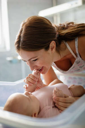 Beautiful mother and her newborn baby together. Love, happiness, family concept.