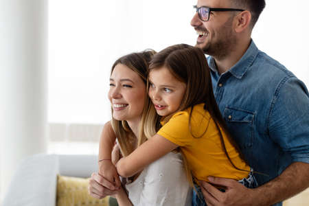 Happy family mother, father and children playing and having fun at homeの写真素材