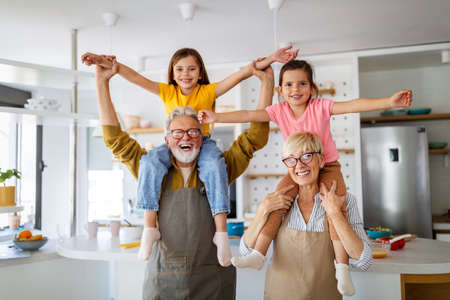 Grandchildren having fun, playing with grandparents at home