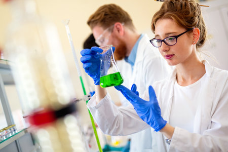 Group of medical research scientists collectively working in laboratoryの写真素材