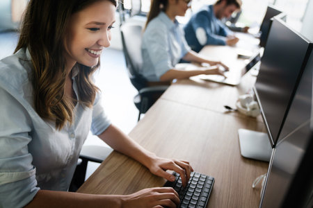 Successful happy woman working at office. Technology, computer, startup, business concept.の写真素材