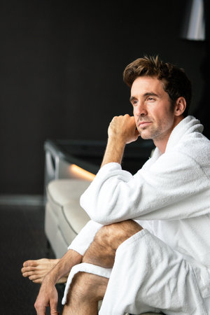 Handsome man in bathrobe relaxing at spa wellness hotelの写真素材