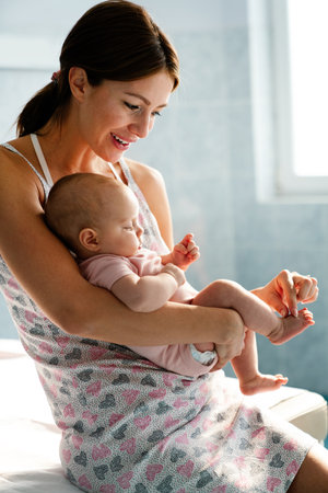 Happy cheerful family. Mother and baby kissing, laughing and huggingの写真素材