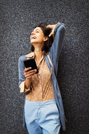 Young beautiful happy woman using smart phoneの写真素材