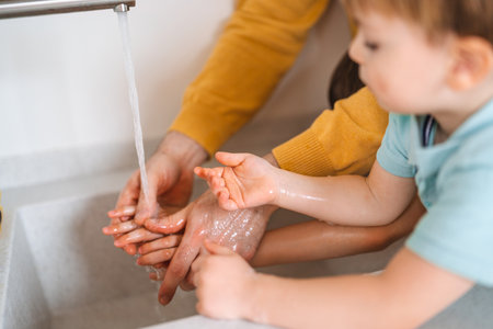 Beautiful young family are washing their hand. Protection against infection and virus.の写真素材