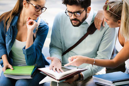 College students studying on university campus outdoorの写真素材