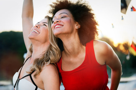 Group of beautiful people friends celebrating, dancing and having fun together outdoorの写真素材