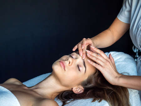 Beautiful woman getting a face treatment at beauty salon.