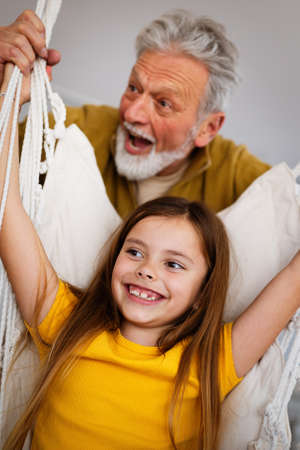 Happy grandparent playing, having fun with grandchildrenの写真素材